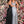 Clarisse 8019 is an a-line prom dress with a v-neck bodice adorned in floral embroidered appliques, an open back, and flowy glitter-flocked novelty fabric skirt.