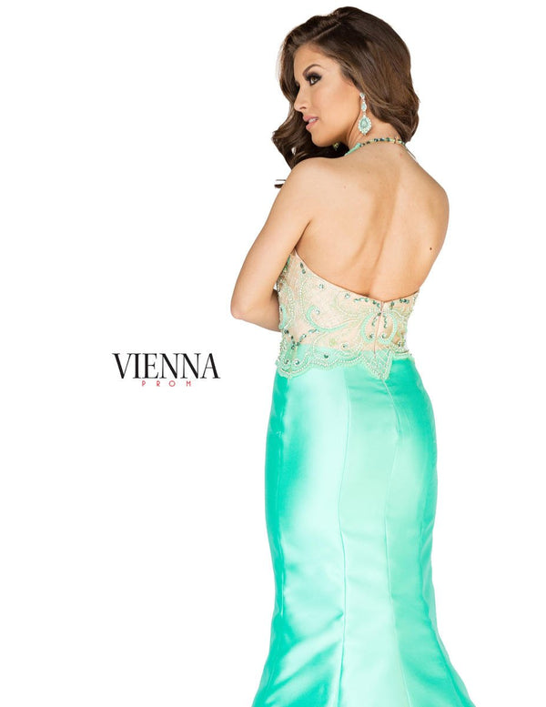 Exquisitely beaded nude illusion bodice with halter neckline completes the sleek silhouette and fitted Mint mikado mermaid skirt.